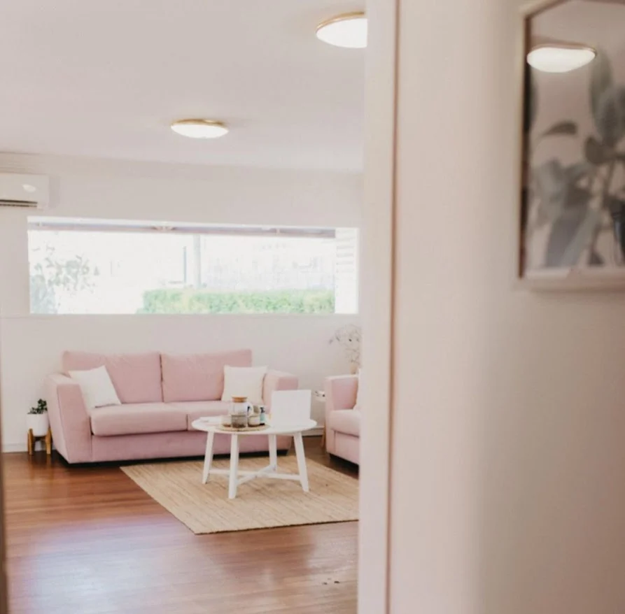 Serene AnaHealings office with soft pink seating
